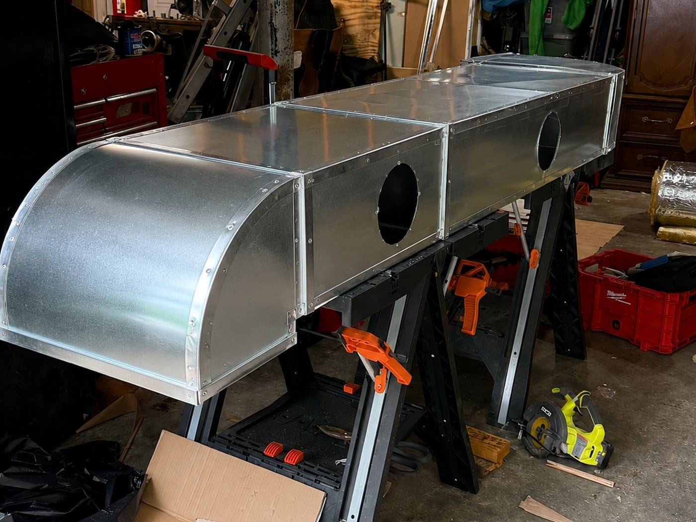 A supply trunk and plenum fabricated in the shop for a duct redesign at a lake house