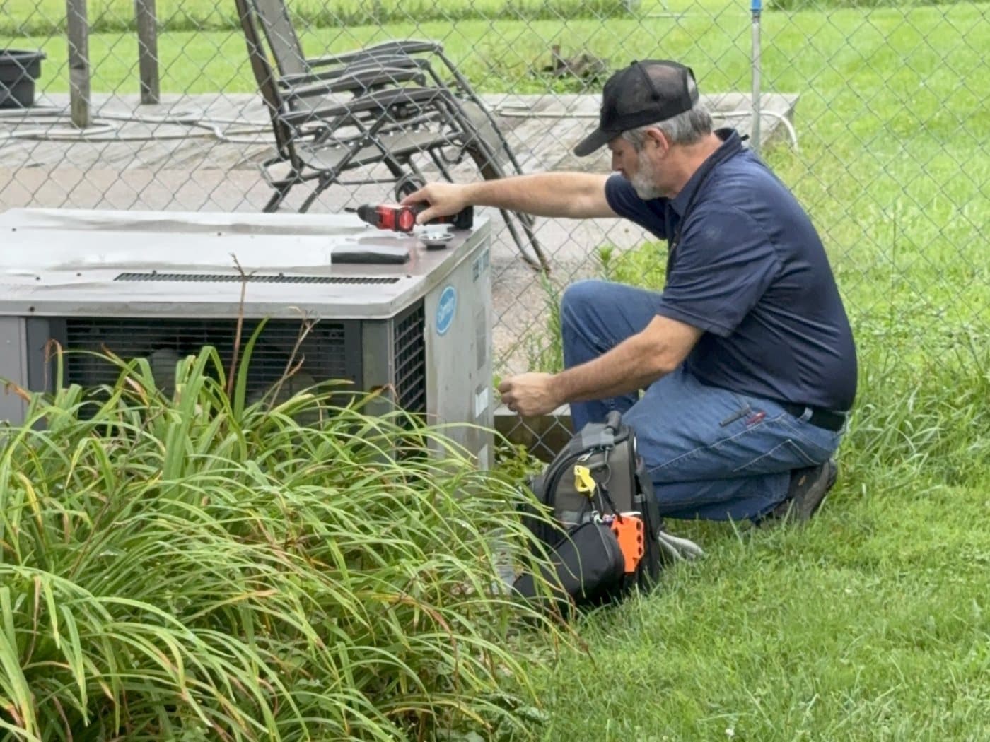 Russell servicing a Carrier package unit at a member's home