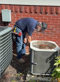 Russell working on a newly installed air conditioning system during commissioning